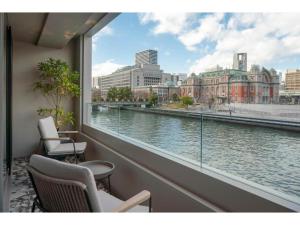 a balcony with chairs and a view of a river at THE BOLY OSAKA - Vacation STAY 52036v in Osaka