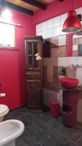 a bathroom with a sink and a red wall at kukachalten in El Chalten