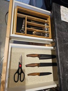 a drawer full of knives and other kitchen utensils at Cozy apartment with amazing view in Calgary