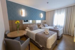 Cama ou camas em um quarto em Nadai Confort Hotel e Spa