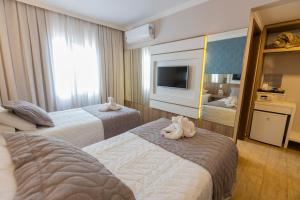 Cama ou camas em um quarto em Nadai Confort Hotel e Spa