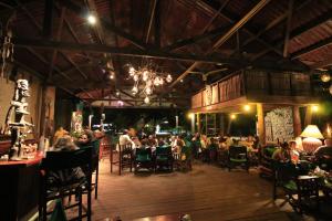 a group of people sitting at tables in a restaurant at Expediciones Mexico Verde in Jalcomulco