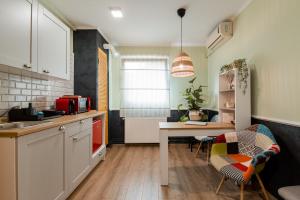 a kitchen with a table and chairs and a dining room at NEW Iorga3 OldCity SelfCheckIn in Timişoara