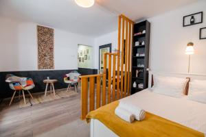 a bedroom with a bed and a table and chairs at NEW Iorga4 OldCity SelfCheckIn in Timişoara