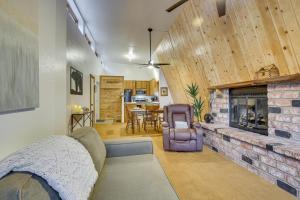 a living room with a couch and a fireplace at The Abby Cabin Restful Running Springs Retreat! in Running Springs