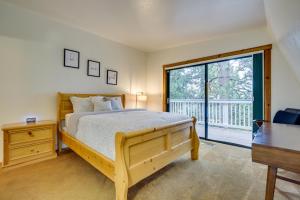 a bedroom with a bed and a large window at The Abby Cabin Restful Running Springs Retreat! in Running Springs