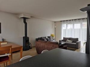 a living room with a fireplace and a couch at Belle maison spacieuse proche Genève et CERN in Saint-Genis-Pouilly