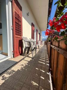 a row of chairs sitting on a sidewalk next to a building at Pippi Home in Castello di Fiemme