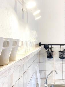 eine Küche mit einer Theke mit Tassen und einer Spüle in der Unterkunft Casa Veronica 5 , 1 Dormitorio in Arona