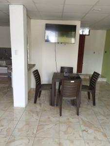 a dining room with a wooden table and chairs at Kiara's house in Puerto Baquerizo Moreno