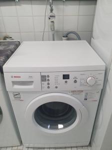 a white washing machine in a small room at Wohnung mit Ausblick in Tauberbischofsheim in Tauberbischofsheim