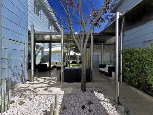 a patio with a tree in the middle of a building at All Time Relais & Sport Hotel in Rome