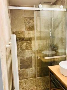a bathroom with a glass shower with a sink at Charming Apartments in City Center - S6 in Luxembourg