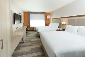 a hotel room with two beds and a flat screen tv at Holiday Inn Express & Suites S Lake Buena Vista by IHG in Kissimmee