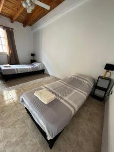 a bedroom with two beds and a ceiling at Complejo Lamadrid - semiprivado in Ciudad Lujan de Cuyo