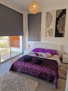 a bedroom with a large bed with two bags on it at Leonidas VILLA in Paphos City