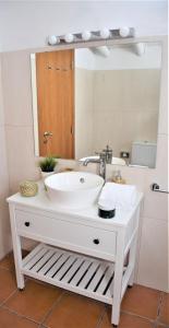 a bathroom with a sink and a mirror at Casa da Chaminé - A Casa da Chaminé "torta" in Amieira +31 photos