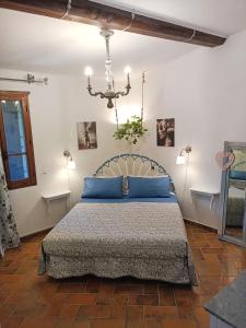 a bedroom with a bed with blue pillows at Casale la Decima in Budrio