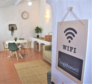 a sign for a wifi sign in a living room at Casa da Chaminé - A Casa da Chaminé "torta" in Amieira