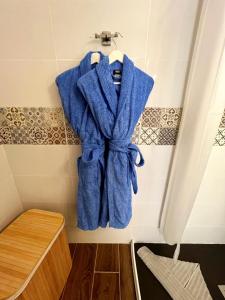 a blue robe hanging on a wall in a bathroom at Cactus del Mar in Tarajalejo