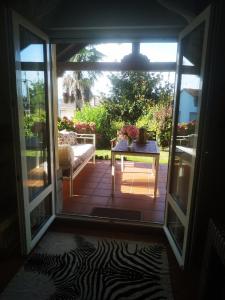 an open door to a patio with a table at El Rincón de las Marismas in Carasa