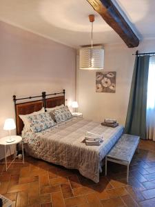 a bedroom with a large bed and a table at Casale la Decima in Budrio