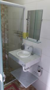 a bathroom with a sink and a mirror at Descanso e aconchego massaguacu in Caraguatatuba +17 photos