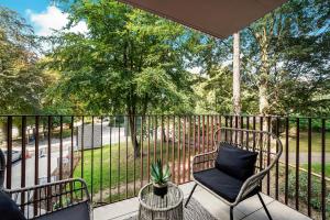 a porch with a chair and a table and a fence at The WaterHouse Avenue by Kandara 5 Star City Home in Maidstone in Maidstone