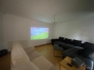 a living room with a couch and a tv at Cosy 3BR Home Close to Villa Park Castle Bromwich off the M6 in Birmingham