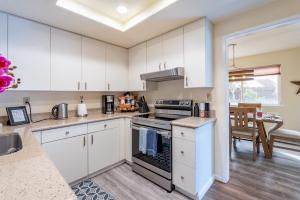 a kitchen with white cabinets and a stove top oven at Dolphin in Marina