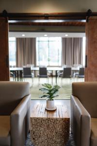 a room with two chairs and a table with a plant on it at Hotel Indigo Traverse City by IHG in Traverse City