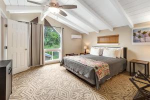 um quarto com uma cama e uma ventoinha de tecto em Sea Turtle Life em Pahoa