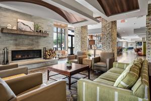 a living room with couches and a fireplace at Hotel Indigo Traverse City, an IHG Hotel in Traverse City