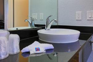 a bathroom with a sink and a towel on a counter at Motel 6-Sacramento, CA - North in Sacramento
