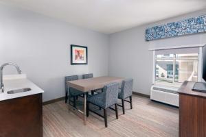 a kitchen with a table and chairs and a sink at Hampton Inn Charlotte Uptown in Charlotte