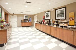 a lobby with a cafeteria with a buffetasteryasteryasteryasteryasteryasteryasteryastery at Hampton Inn & Suites Phoenix Glendale-Westgate in Glendale