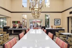 a large dining room with a large white table and chairs at Hampton Inn & Suites Seattle North/Lynnwood in Lynnwood