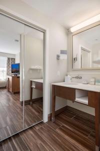 a bathroom with a sink and a mirror at Hampton Inn & Suites Seattle North/Lynnwood in Lynnwood