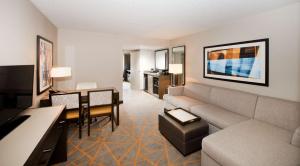 a living room with a couch and a table at Embassy Suites by Hilton Cincinnati Northeast - Blue Ash in Blue Ash