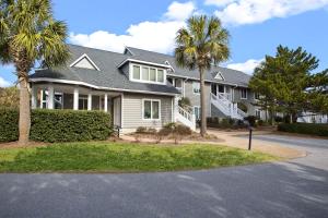 a house with palm trees in front of it at Kingston Plantation Condos in Myrtle Beach