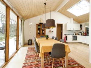 a kitchen and dining room with a table and chairs at Three-Bedroom Holiday home in Rørvig 1 in Rørvig