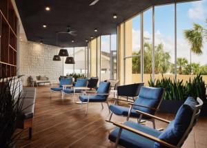 a waiting room with blue chairs and windows at Hilton Myrtle Beach Resort in Myrtle Beach