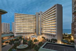 a rendering of a hotel with the ocean in the background at Hilton Myrtle Beach Resort in Myrtle Beach