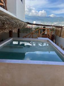 a swimming pool on the roof of a house at Hotel Casa-Noria Acapulco in Acapulco