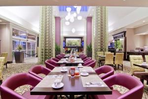 a dining room with purple chairs and tables at Hilton Garden Inn Toronto/Ajax in Ajax