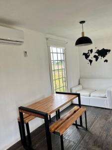 a living room with a table and a couch at CASA CONTENEDOR in Necochea