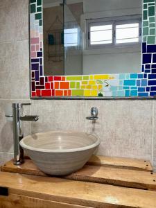 a bathroom with a bowl sink and a mirror at CASA CONTENEDOR in Necochea