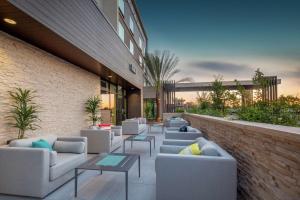 a lobby with couches and tables and a building at Hilton Garden Inn Surprise Phoenix in Surprise