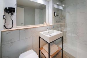 a white bathroom with a sink and a shower at Sure Hotel by Best Western Rochefort-sur-Mer in Tonnay-Charente +80 photos