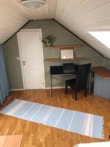 een zolderkamer met een bureau en een laptop bij King size bed, hjem med utsikt, gratis parkering in Bodø